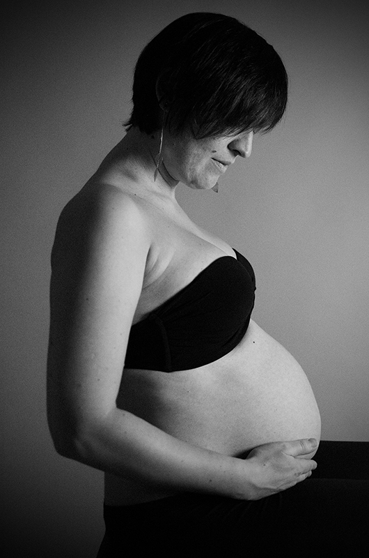 Photo de grossesse en noir et blanc studio photo